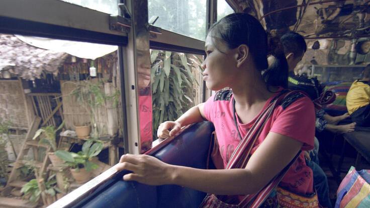 As a bus prepares to leave Mae La camp in Thailand, a Burmese woman looks out the window to say goodbye for the last time.