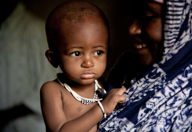 Mother smiling holding her baby.