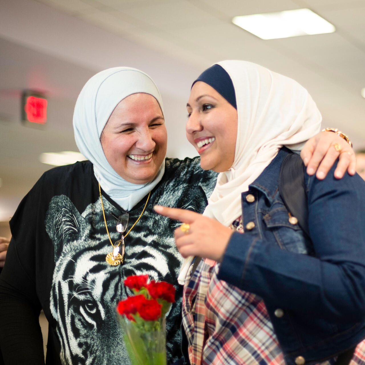 Two women laughing and smiling.