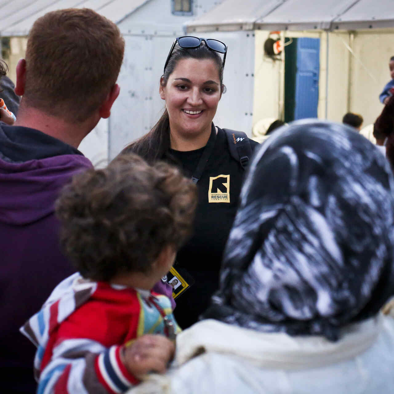 IRC staff member talking to a group of people