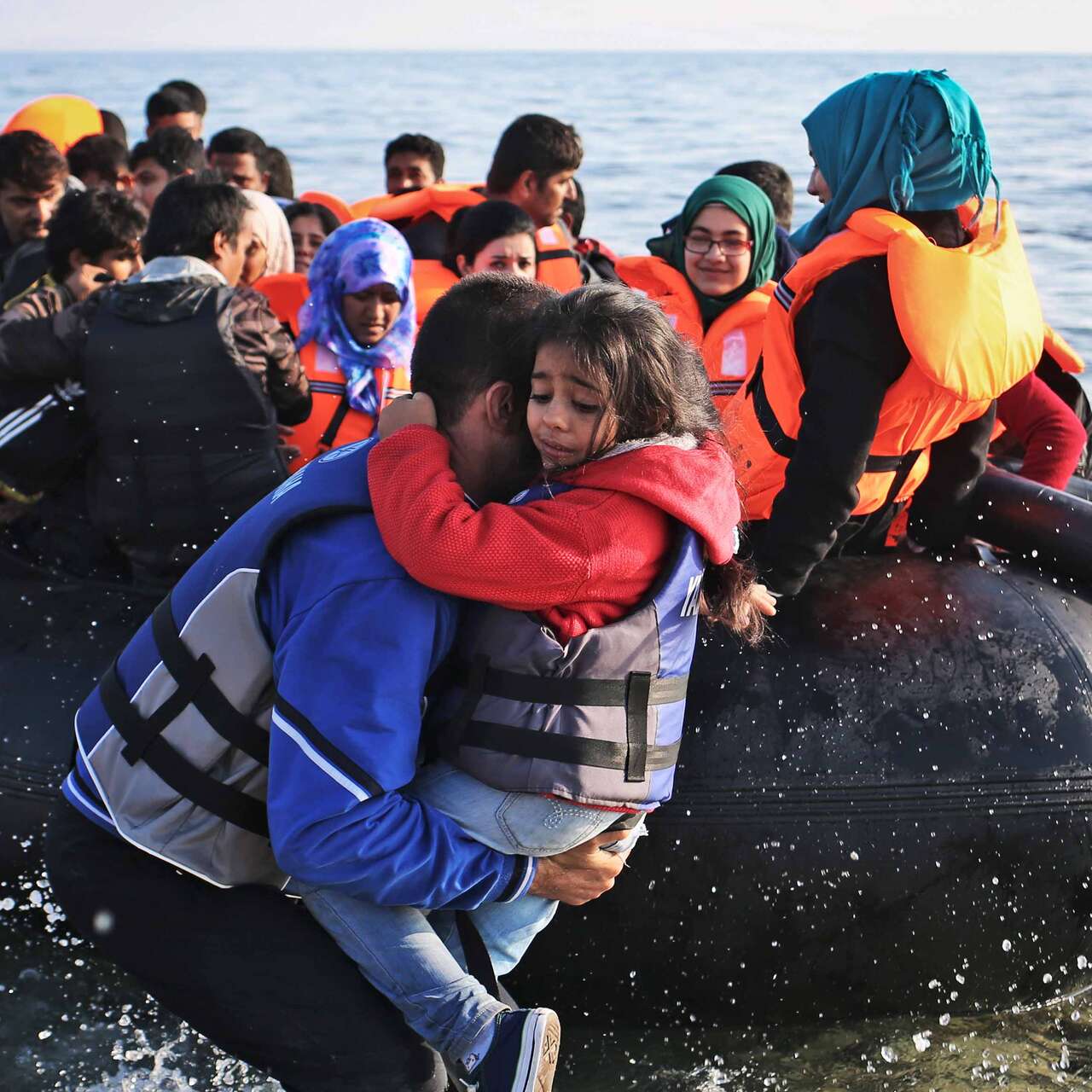 People jumping from a small boat