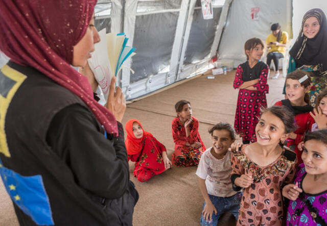 Woman teaching children.