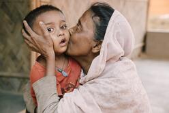 A mother kisses and her grandson