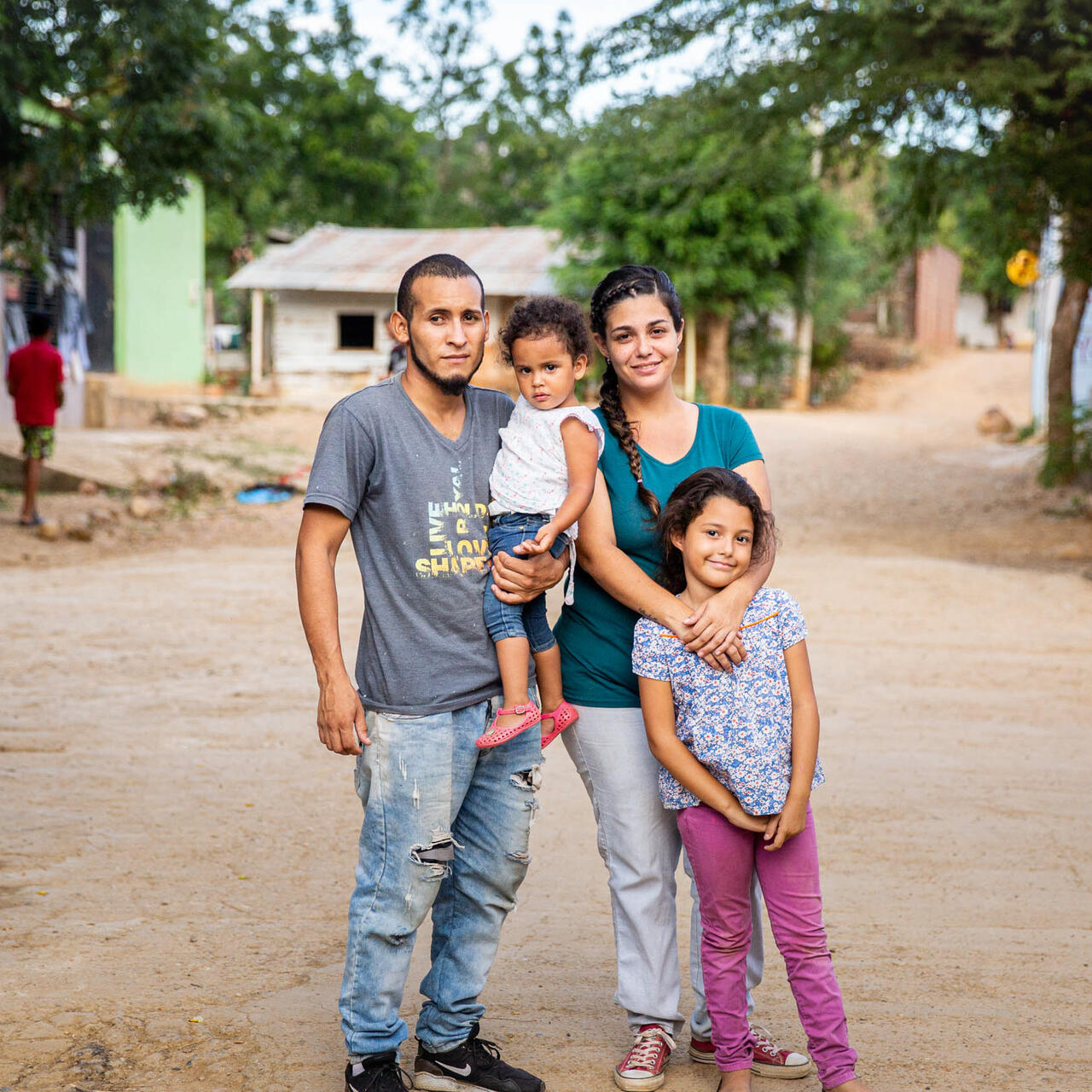 A family stop in the road to pose for a picture.