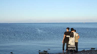 Iranian mother, Wahida with her two sons, Puria, 15, and Neema, 10, on the Greek island of Lesvos.