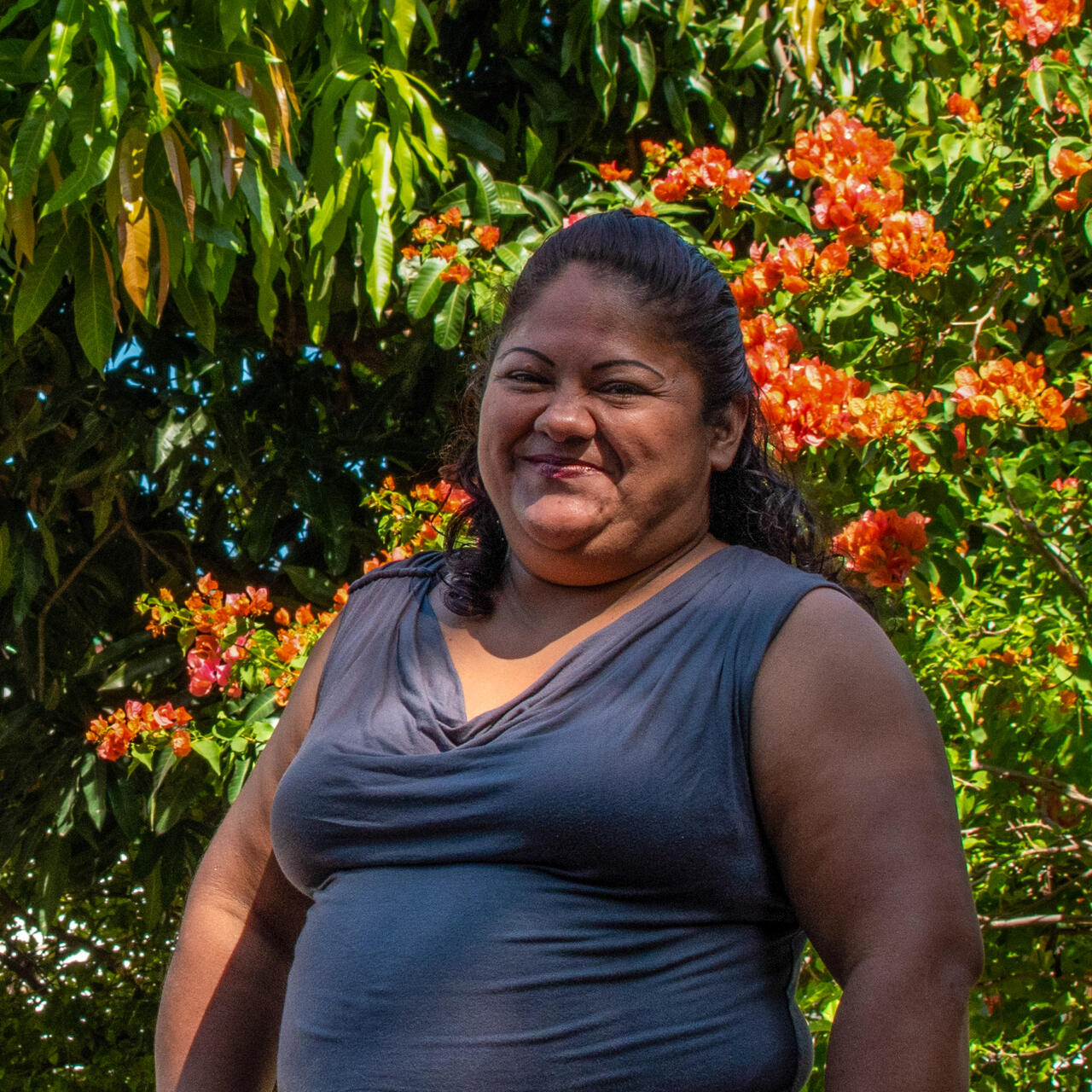 A woman poses for a portrait outside in El Salvador.