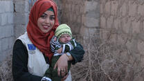 Portrait of Dr. Bushra holding a baby