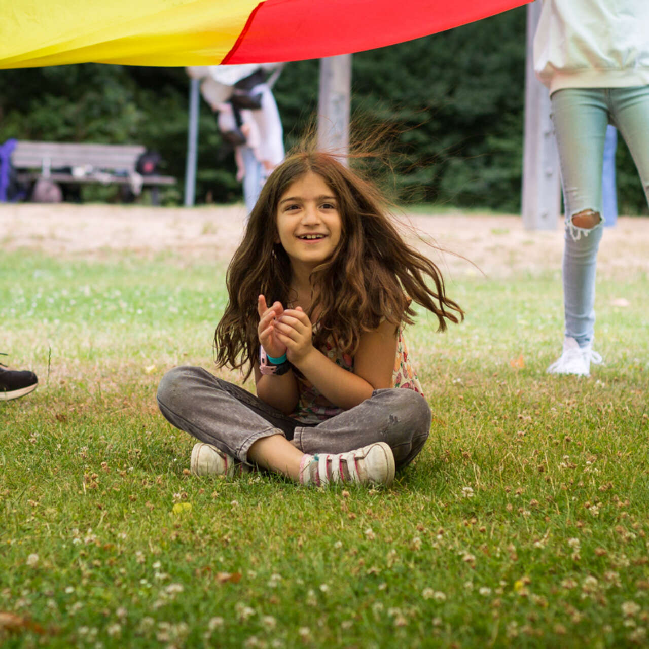 A girl participates at an IRC activity in a park in Germany.