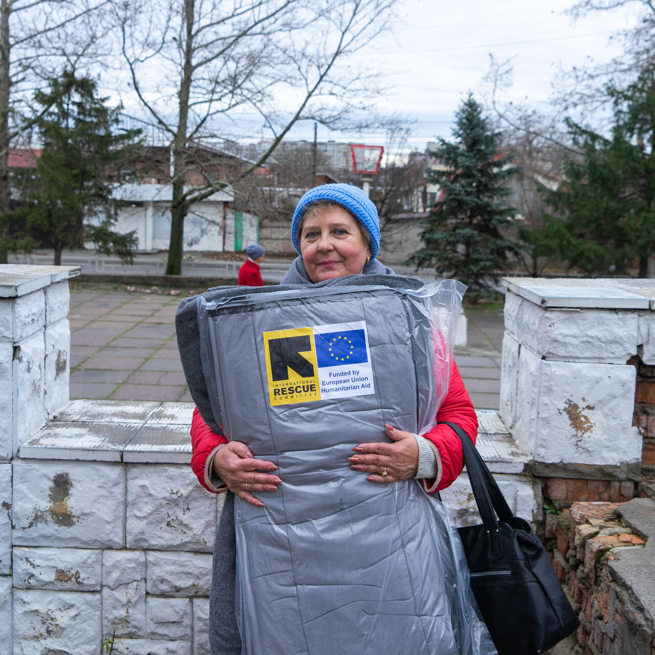 A woman in Ukraine receives a winter kit from the IRC