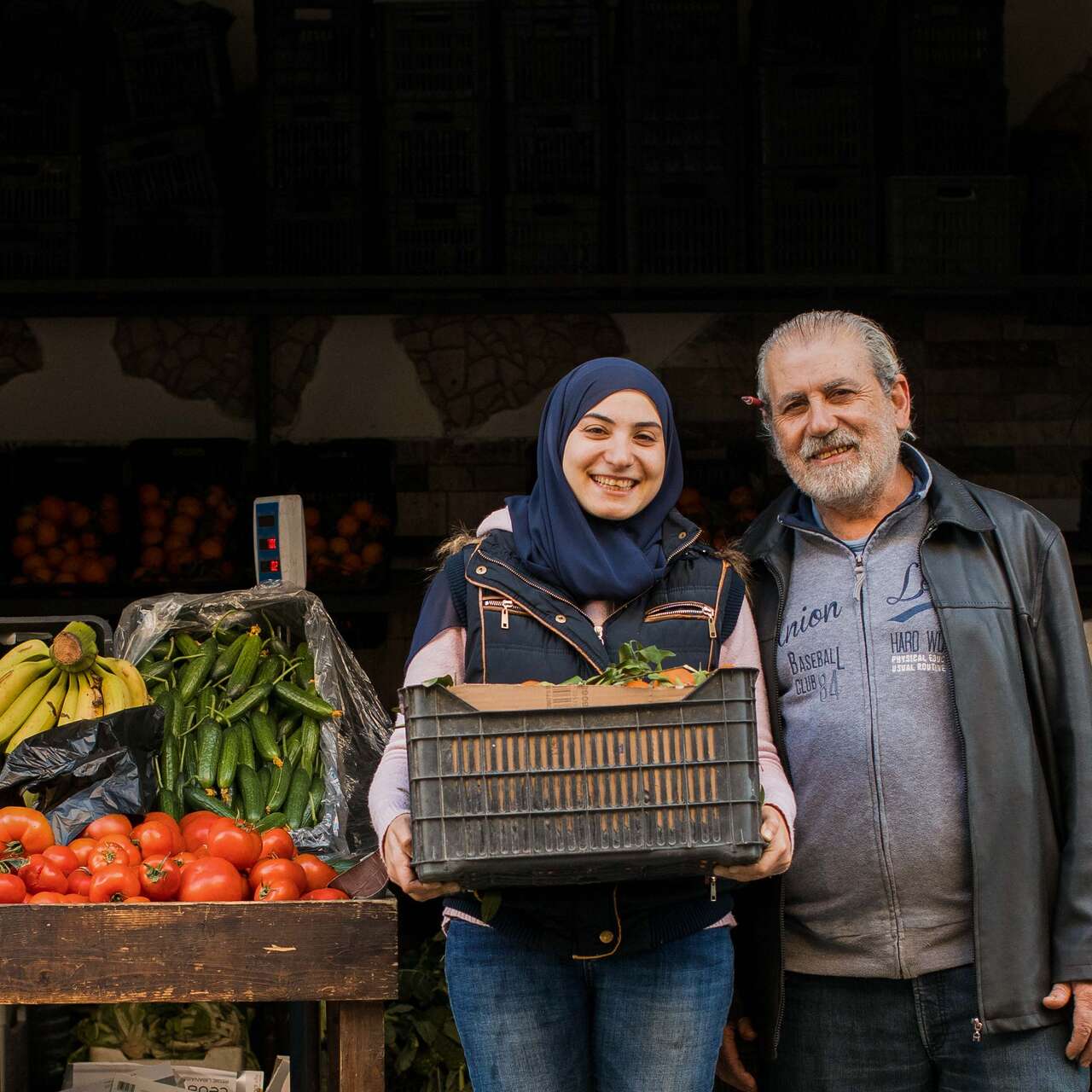 A daughter and father poses for a photo outside of their shop in Lebanon.