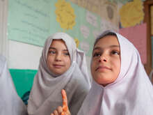 A group of girls study together in a classroom in Afghanistan.