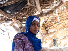 A woman poses for a photo outside in Mali.