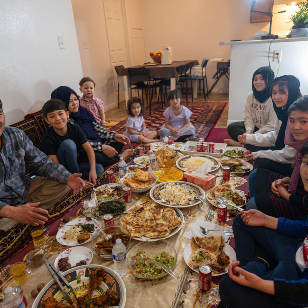 The Hussaini family sit around their prepared Iftar meal.