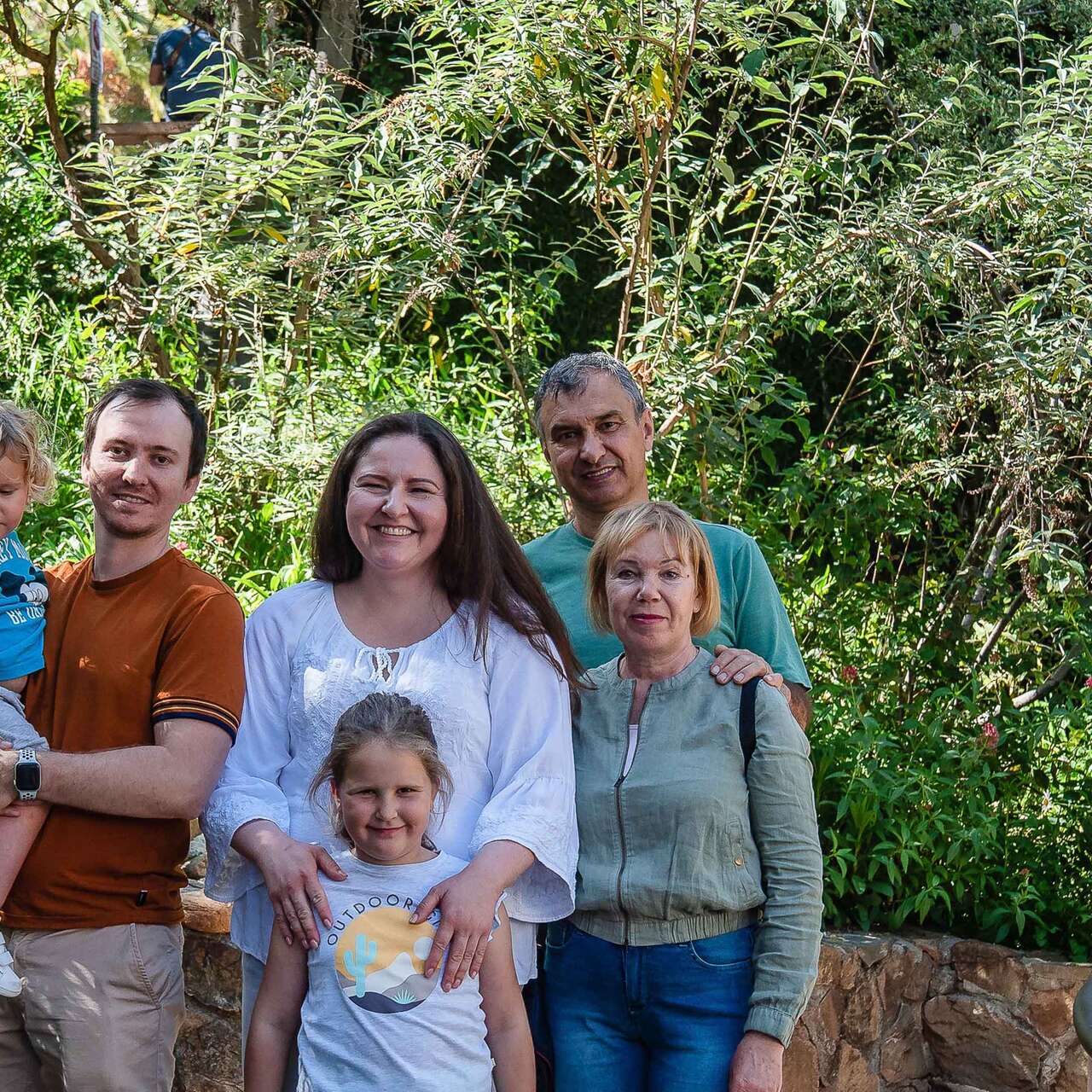 A Ukrainian refugee family poses for a photo outside in San Diego.