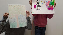 Karima's children holding drawings