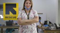 Dr Gomez stands with her arms folded in front of her office