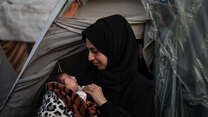 24-year-old Palestinian Safaa holds her baby daughter.