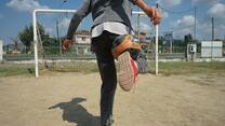 boy makes a trick with a football