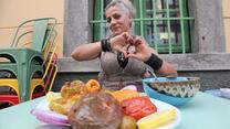 Jacqueline makes the symbol of a heart over a plate of food 