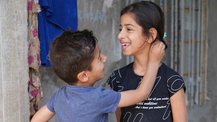 Two Iraqi children play together.