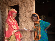 Women giving out cash in Ethiopia