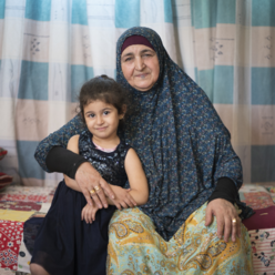 A mother and daughter seated together.